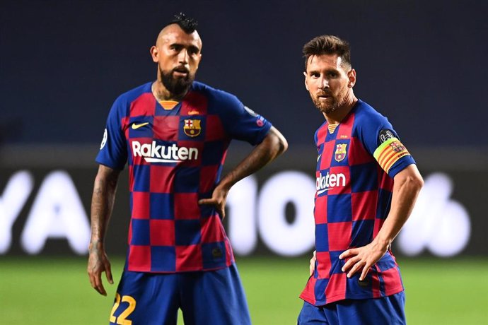 Barcelona's Lionel Messi (R) and Arturo Vidal look dejected during the UEFA Champions League Quarter Final soccer match between FC Barcelona and FC Bayern Munich at Jose Alvalade Stadium.