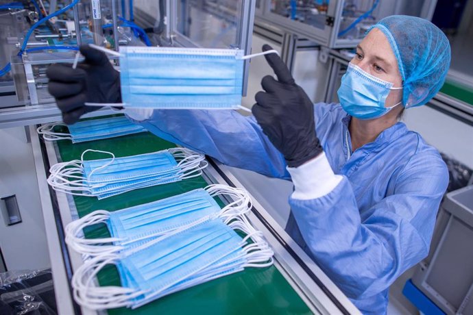 Una empleada revisa máscarillas en una fábrica de la empresa BM Bioscience Technology