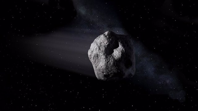 Esta ilustración muestra un asteroide cercano a la Tierra como el asteroide 2020 SW viajando a través del espacio