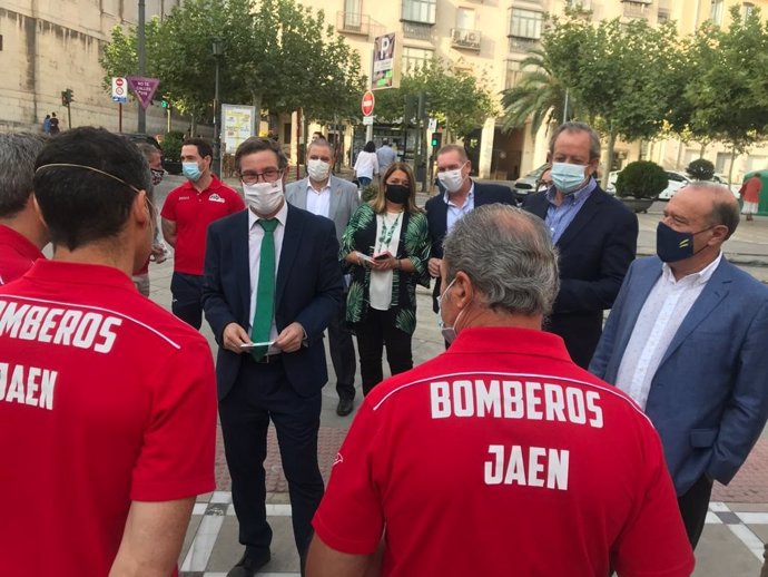 Contreras (c) conversa con representantes de los Bomberos de Jaén antes del pleno de la Diputación.