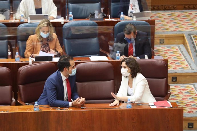 La presidenta de la Comunidad de Madrid, Isabel Díaz Ayuso, habla con el vicepresidente de la Comunidad, Ignacio Aguado, durante una sesión plenaria en la Asamblea de Madrid, en Madrid (España) a 1 de octubre de 2020. El Gobierno regional aprueba en est