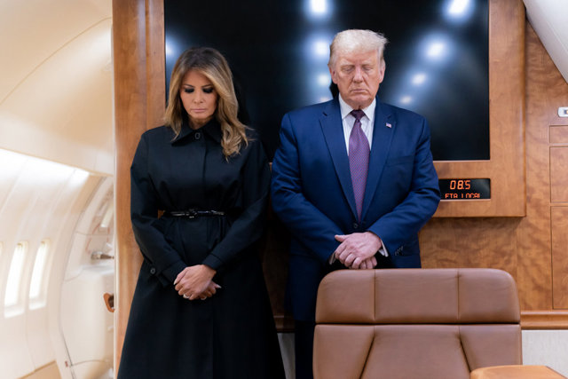 HANDOUT - 11 September 2020, US, Pennsylvania: US President Donald Trump (R) and First Lady Melania Trump bow their heads during a moment of silence aboard Air Force One to mark.