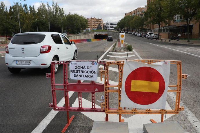 Un coche pasa junto a un cartel que indica que accede a una zona de restricción sanitaria en el municipio madrileño de Alcobendas