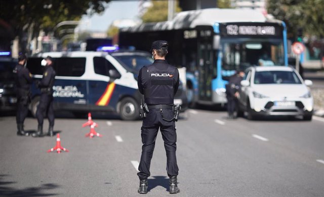 Un agente de la Policía Nacional vigila durante un control policial de movilidad en Madrid (España), a 6 de octubre de 2020.