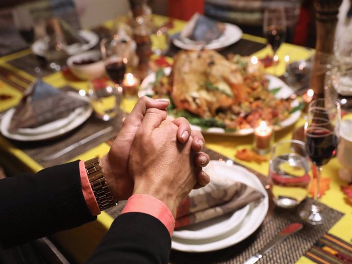 Central American immigrants and their families pray before Thanksgiving dinner on November 24, 2016 in Stamford, Connecticut.