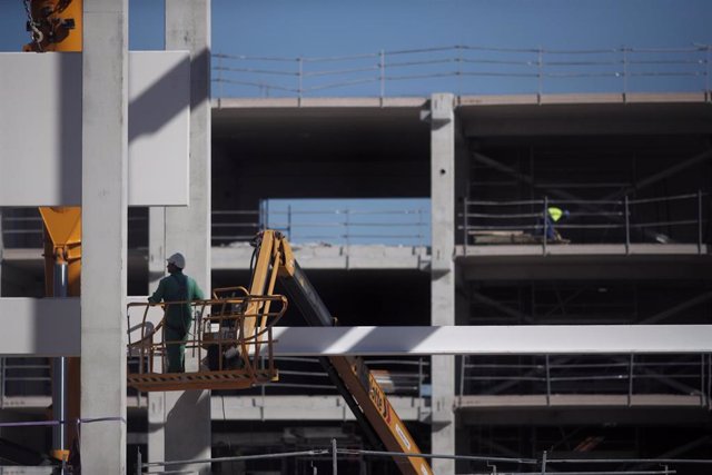 Varios obreros trabajan con maquinaria de construcción en las obras del nuevo Hospital de Emergencias de la Comunidad de Madrid
