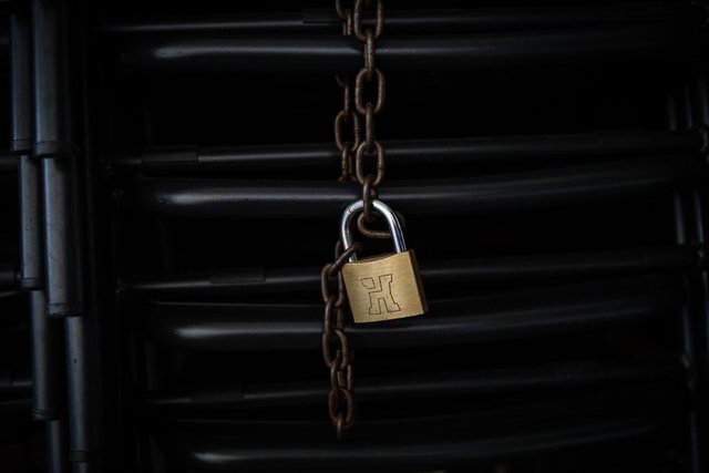 Candado en las sillas de una terraza de un bar cerrado durante el cuarto día de la entrada en vigor de las nuevas restricciones en Cataluña, en Barcelona, Cataluña (España) a 20 de octubre de 2020. 