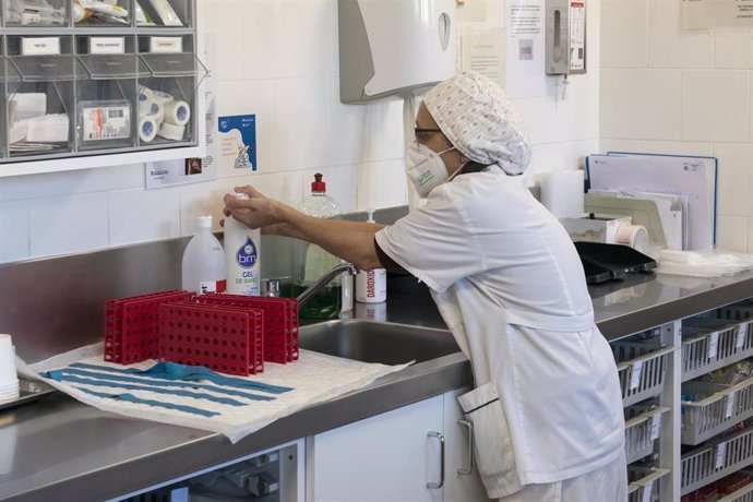 Una trabajadora sanitaria se desinfecta las manos en el CAP Masdevall el día en el que comienza la campaña de vacunación antigripal en la región, en Figueres, Girona (Catalunya)