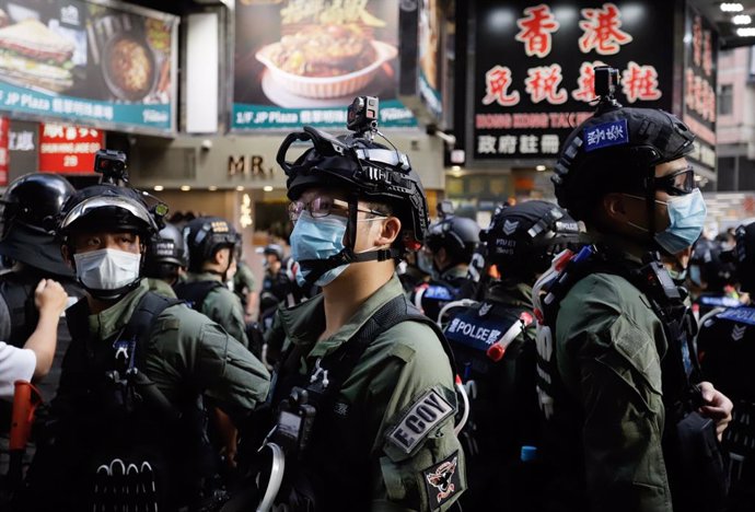 01 October 2020, China, Hong Kong: Riot police stand guard on streets during a p