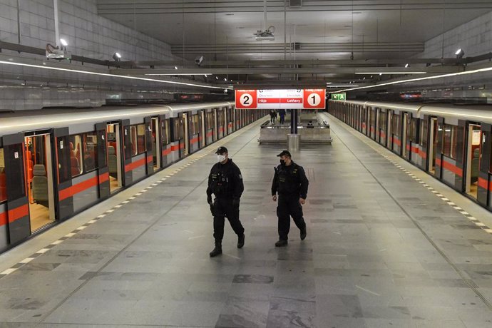 28 October 2020, Czech Republic, Prague: Police officers patrol at the Museum metro station before the start of the night-time curfew which was imposed by the government between 9 pm and 5 am to curb the coronavirus (Covid-19) infections. Photo: Vít ?im