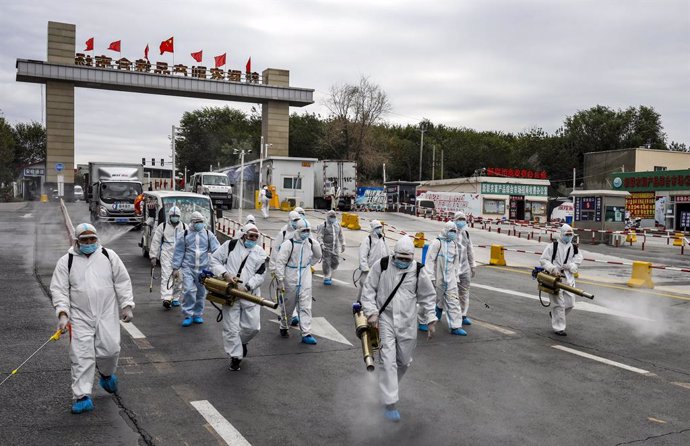 26 August 2020, China, Urumchi: Workers wear protective suits take part in a disinfection process for a street amid the spread of the coronavirus (COVID-19) pandemic. Photo: -/TPG via ZUMA Press/dpa