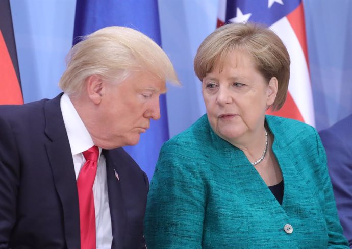 FILED - 08 July 2017, Hamburg: US President Donald Trump (L), speaks with German Chancellor Angela Merkel during a panel discussion at the G20 summit. German Chancellor Angela Merkel has declined an invitation fromUS President Donald Trump to the upcom