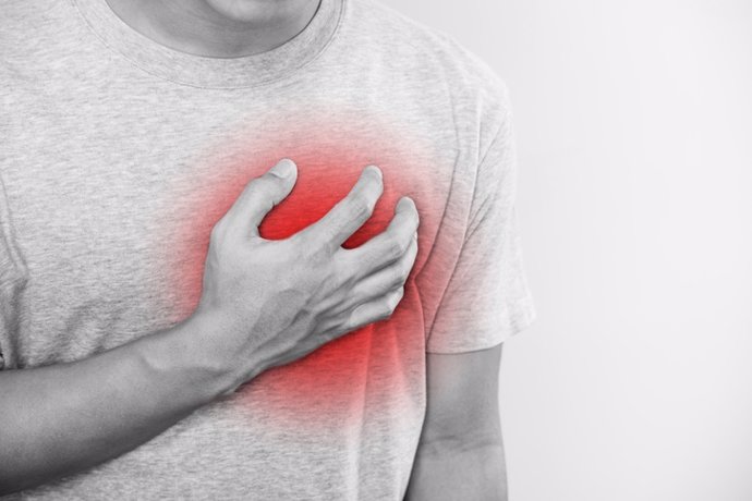 A man touching his heart, with red highlight of heart attack,heart failure and others heart disease