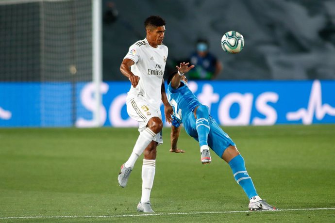 Raphael Varane of Real Madrid and Maximiliano Gomez of Valencia in action during the spanish league, LaLiga, football match played between Real Madrid and Valencia at Alfredo Di Stefano Stadium on June 18, 2020 in Valdebebas, Madrid, Spain. The Spanish 