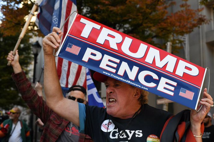 07 November 2020, US, Philadelphia: A man supporting Donald Trump reacts in frustration after former vice president Joe Biden has been projected to win the White House, bringing an end to President Donald Trump atop the United States' most powerful offi