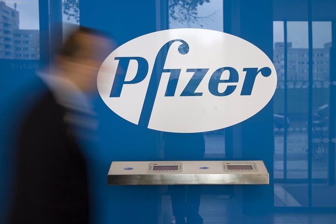 FILED - 06 October 2008, Berlin: A man walks past the logo of the multinational pharmaceutical corporation Pfizer in Berlin. Drug-maker Pfizer says the company may know by the end of October whether its coronavirus vaccine is effective and safe, chief e