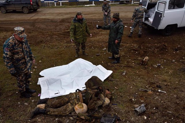 Militares armenios junto al cuerpo de un soldado azerí en Nagorno Karabaj