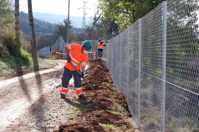 Trabajadores en la instalación de las barreras protectores del canal de Gavet (Lleida)