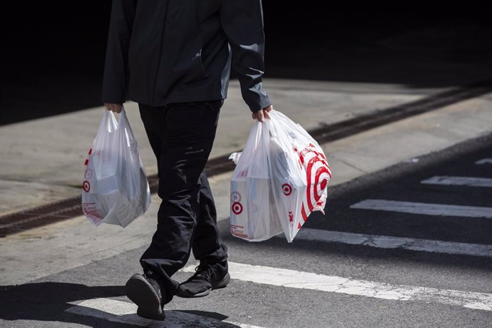 March 30, 2019 - New York, New York, United States: A man carries Target plastic shopping bags on east 117th Street in Manhattan. (Natan Dvir / Contacto Images)