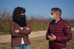 La consellera Jord con el propietario de la parcela donde se hará la prueba piloto de cultivo del kiwi