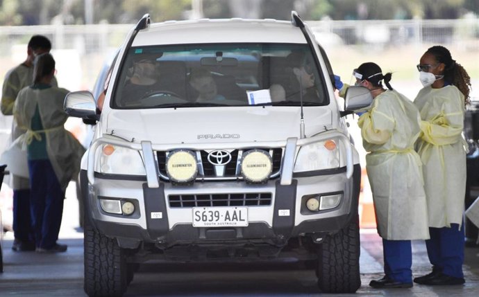Health workers test the public at a drive through COVID testing site at Victoria Park in Adelaide, Thursday, November 19, 2020. South Australia will go into lockdown for six days, with a range of restrictions to provide a "circuit-breaker" and help cont