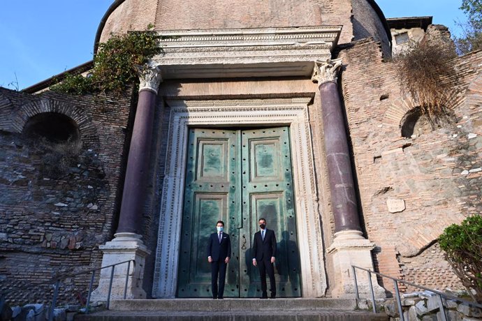 El presidente del Gobierno, Pedro Sánchez (d), y el primer ministro de Italia, Giuseppe Conte (i), posan junto a la puerta de cobre verde del templo de Rómulo y Remo en el Foro Romano, en Roma (Italia), a 20 de octubre de 2020.