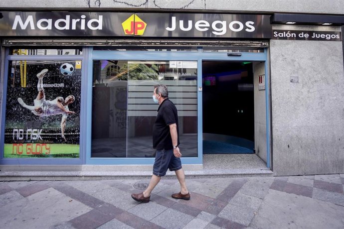 Un hombre pasa al lado de un local de apuestas ubicado en el centro de la capital, en Madrid, (España), a 28 de agosto de 2020.