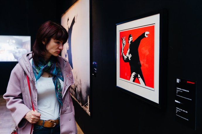 Una visitante observa una obra de la exposición de Banksy en el Círculo de Bellas Artes