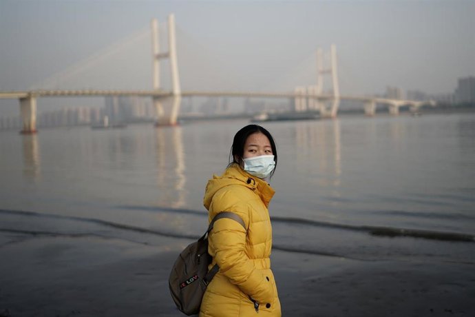 Una mujer con mascarilla en Wuhan (China)