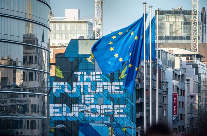29 January 2020, Belgium, Brussels: European flags wave near a mural painting with the inscription of "The Future is Europe". Britain is due to leave the EU at midnight on Friday, three-and-a-half years after Britons narrowly voted on the issue in a 201