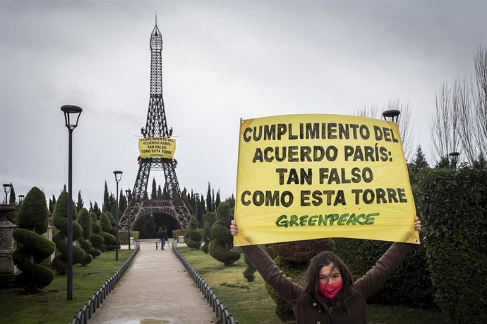 Activistas de Greenpeace se han encaramado a una réplica de la torre Eiffel en Torrejón de Ardoz (Madrid) para denunciar la falta de cumplimiento del Acuerdo del Clima de París