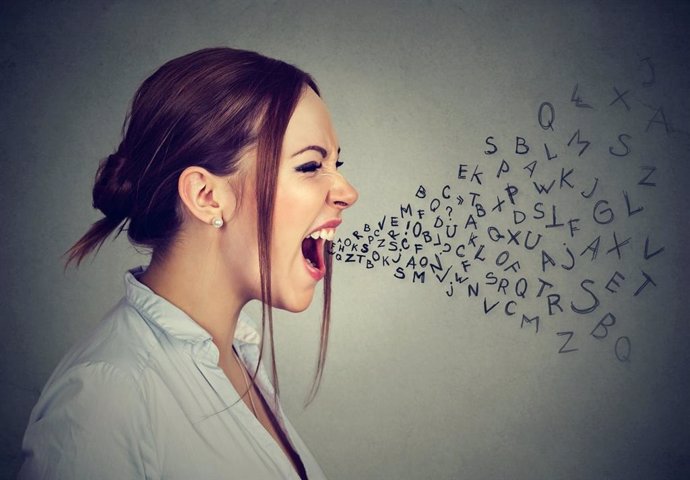 Side profile angry woman screaming with alphabet letters flying out of wide open mouth