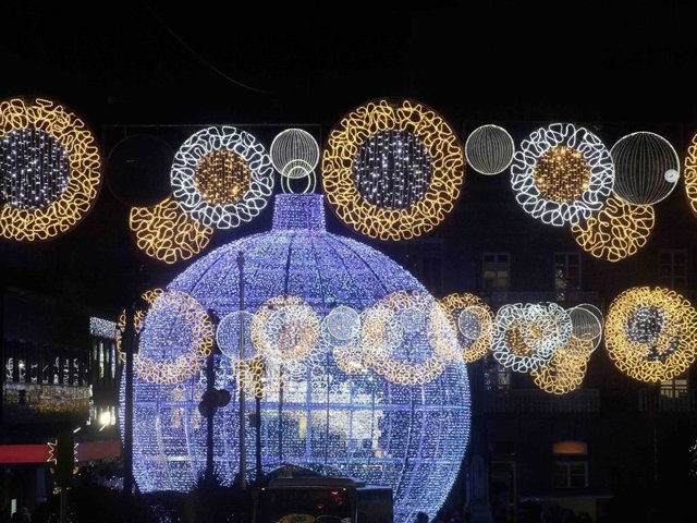 Street light Christmas decorations,  large  illuminated Christmas tree ball and tinsel in Vigo, Galicia, Spain.