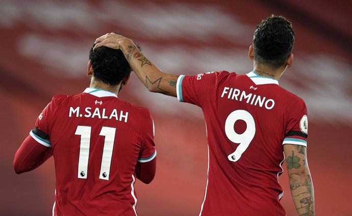 16 December 2020, England, Liverpool: Liverpool's Mohamed Salah celebrates his side's first goal with his team mate Roberto Firmino during the English Premier League soccer match between Liverpool and Tottenham Hotspur at the Anfield stadium. Photo: Pet