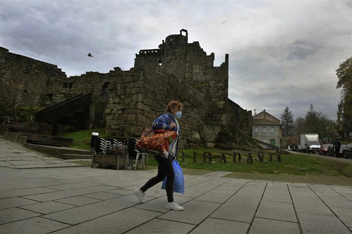 Una persona camina por una de las calles de Ribadavia el día de la entrada en vigor de nuevas medidas y del cierre perimetral del municipio debido a la crisis del Covid-19, en Ribadavia, Ourense, Galicia, (España), a 14 de noviembre de 2020. Este y otro