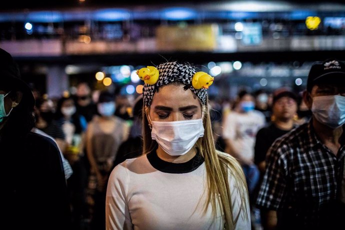 02 December 2020, Thailand, Bangkok: A pro-democracy protester prays after watching a movie on the conflict between the Thai army and the Red Shirts protesters in 2010 were 99 people lost their lives, during an anti-government demonstration in the Thai 