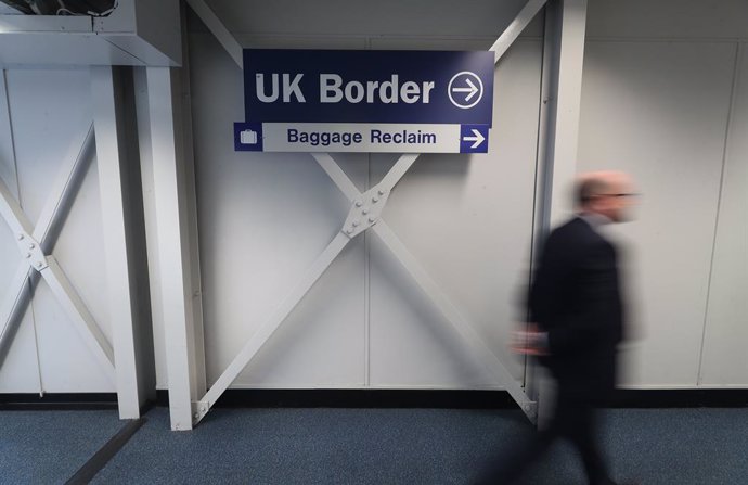 11 June 2020, Northern Ireland, Belfast: A man passes a UK border sign at Belfast International Airport which reopens on 15 June 2020. Photo: Niall Carson/PA Wire/dpa