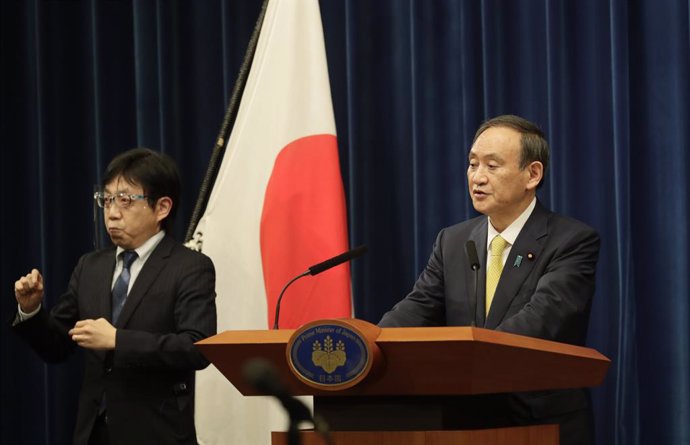 04 December 2020, Japan, Tokyo: Japanese Prime Minister Yoshihide Suga (R) speaks during a press conference. Photo: -/Pool Photo via ZUMA Wire/dpa