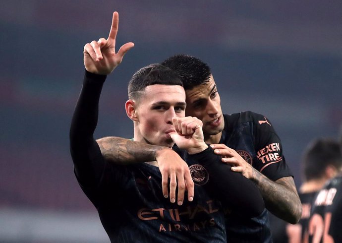 22 December 2020, England, London: Manchester City's Phil Foden celebrates scoring his side's third goal during the English Carabao Cup Quarter Final soccer match between Arsenal and Manchester City at The Emirates Stadium. Photo: Nick Potts/PA Wire/dpa