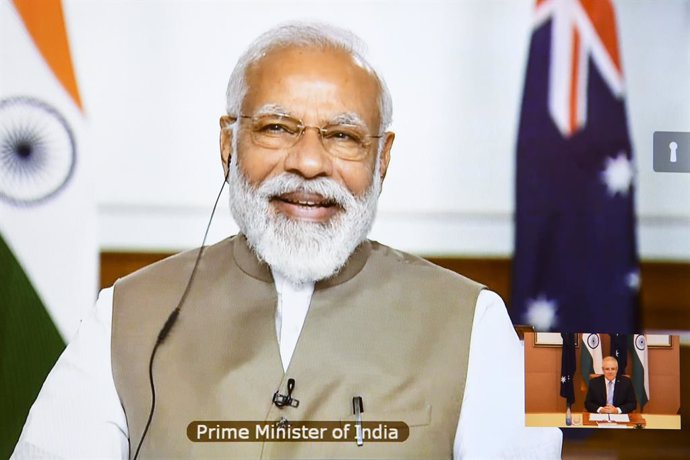 Australian Prime Minister Scott Morrison and Indian Prime Minister Narendra Modi are seen on a conference screen during the 2020 Virtual Leaders Summit between Australia and India at Parliament House in Canberra, Thursday, June 4, 2020. (AAP Image/Lukas
