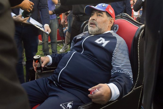 29 October 2019, Argentina, Rosario: Argentinian Coach and former football player Diego Maradona sits in an armchair. Newell's football team gave Maradona as a tribute a picture as a player in the team. Photo: Sebastian Granata/telam/dpa