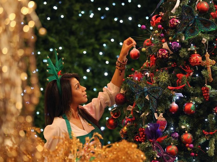 An employee hangs a decoration on a tree in the Christmas shop at Selfridges department store on August 2, 2010 in London, England. Selfridges launched its Christmas shop today, 145 days ahead of Christmas Day.