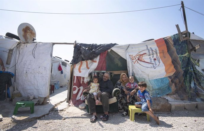 12 June 2019, Lebanon, ---: Members of a refugee family sit outside their tente during the visit of Sophie (not pictured), the Countess of Wessex, to an informal tented settlement, which houses refugees displaced to Lebanon by the Syrian conflict. Photo