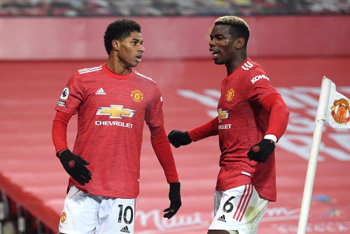 29 December 2020, England, Manchester: Manchester United's Marcus Rashford (L) celebrates scoring his side's first goal with teammate Paul Pogba during the English Premier League soccer match between Manchester United and Wolverhampton Wanderers at Old 