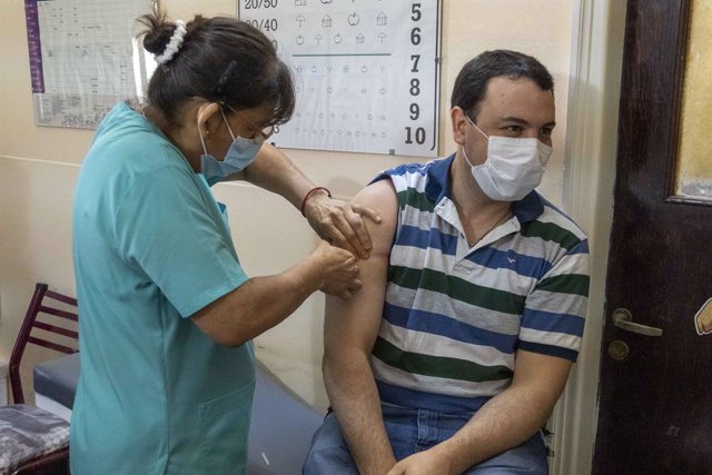29 December 2020, Argentina, Firmat: Dr.Emilio Focco (R), San Martin Hospital Medical Director, gets his dose of the Russian Sputnik V vaccine amid a nationwide vaccination campaign. Photo: Patricio Murphy/ZUMA Wire/dpa
