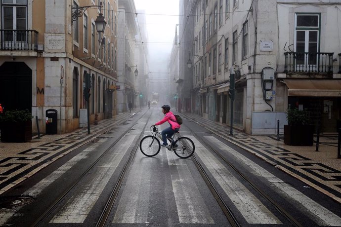 09 November 2020, Portugal, Lisbon: A woman rides a bicycle in downtown Lisbon. Portugal returned to the state of emergency until 23 November amid the rising numbers of Coronavirus infections. Photo: Pedro Fiuza/ZUMA Wire/dpa