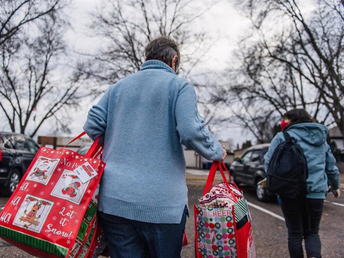 Community outreach and volunteer coordinator Joa Sevlie (L), and a volunteer load Christmas gifts on December 21, 2020 in St Paul, Minnesota.