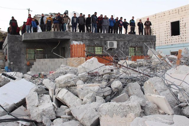 Un grupo de palestinos mira las ruinas de una casa demolida cerca de Hebrón por el Ejército israelí.