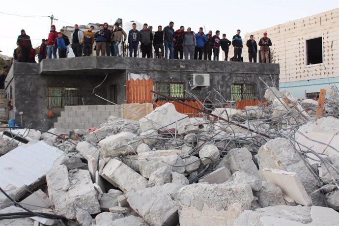 27 November 2019, Palestinian Territories, Hebron: Palestinians inspect the rubble of the houses that were demolished by the Israeli army in the West Bank village of Biet Kahel near Hebron. The Israeli army demolished homes belonging to four  Palestinia