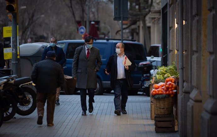 El ministro de Sanidad, Salvador Illa, y el primer secretario del PSC, Miquel Iceta, caminan por la calle Consell de Cent en dirección a la sede del PSC Barcelona, en Barcelona, Cataluña (España), a 30 de diciembre de 2020. 
